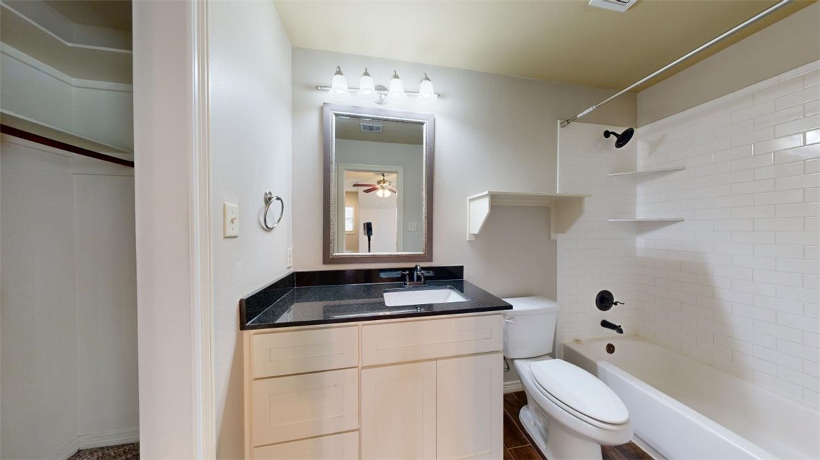 102 Richards Street College Station, TX 77840 - Photo 33 of 41 a bathroom with a granite countertop toilet and sink