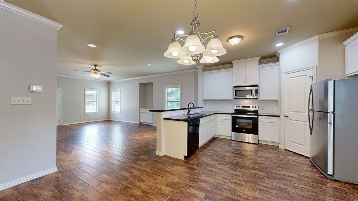 102 Richards Street College Station, TX 77840 - Photo 40 of 41 a kitchen with a refrigerator and chandelier