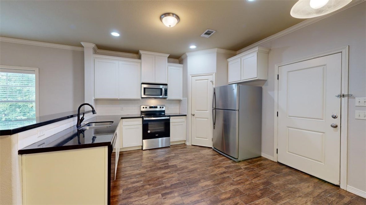 102 Richards Street College Station, TX 77840 - Photo 5 of 41 a kitchen with granite countertop a refrigerator and a sink