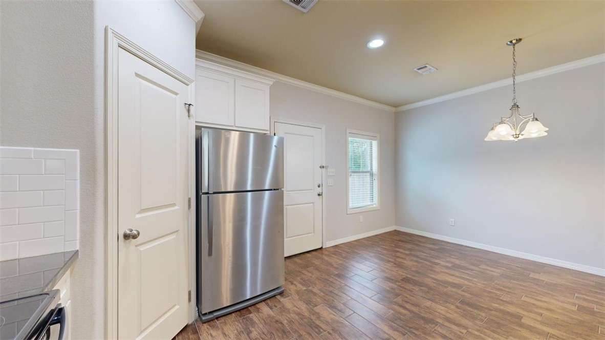 102 Richards Street College Station, TX 77840 - Photo 8 of 41 a kitchen with stainless steel appliances a refrigerator and wooden floor