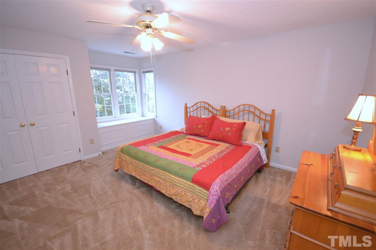 24 Renwick Court Raleigh, NC 27615 - Photo 16 of 20 a bedroom with a bed dresser and a window
