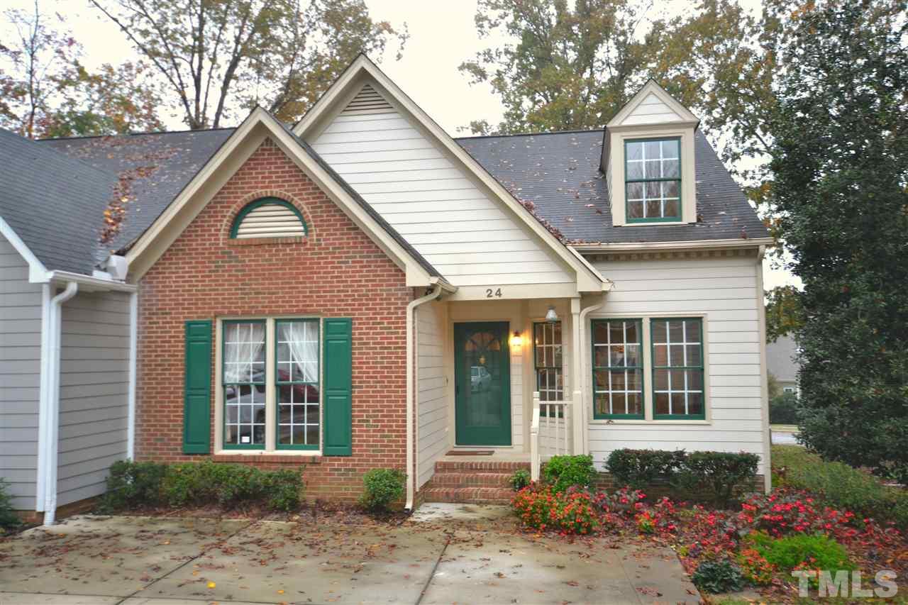 24 Renwick Court Raleigh, NC 27615 - Photo 20 of 20 a front view of a house with a yard and potted plants