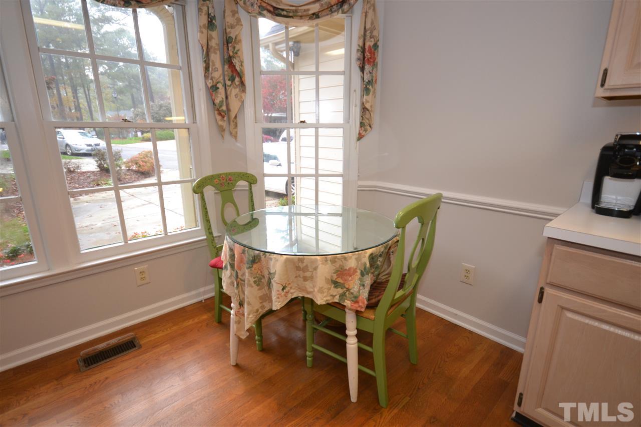 24 Renwick Court Raleigh, NC 27615 - Photo 3 of 20 a dining room with furniture a chandelier and wooden floor