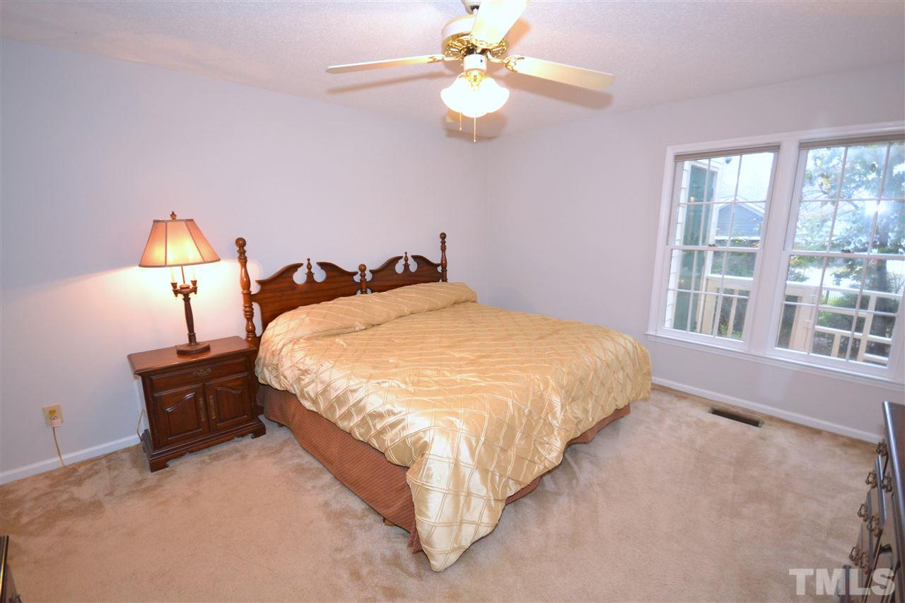 24 Renwick Court Raleigh, NC 27615 - Photo 8 of 20 a large bed sitting in a bedroom next to a window