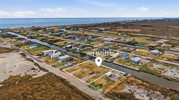 an aerial view of residential building and ocean view