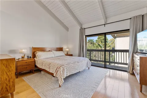 a bedroom with a large bed and a large window