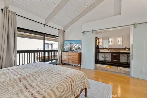 a bedroom with a large bed and a tv