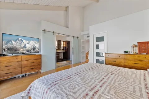 a bedroom with a bed and a dresser