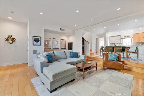 a living room with furniture and kitchen view