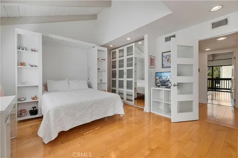a spacious bedroom with a bed and cabinets