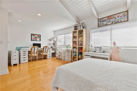 a bedroom with furniture and a large window
