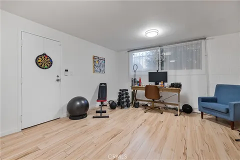 a view of a workspace with furniture and a window