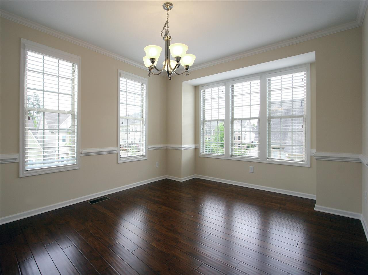 1517 Rodessa Run Raleigh, NC 27607 - Photo 10 of 25 Wow! Entertain in style in this beautiful dining room. Note the large bay window, hardwood floor, chair rail, crown molding, and brushed nickel light fixture. Plenty of room for your large furniture pieces. Dining Room