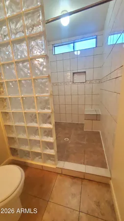 a bathroom with a toilet a sink a mirror and vanity