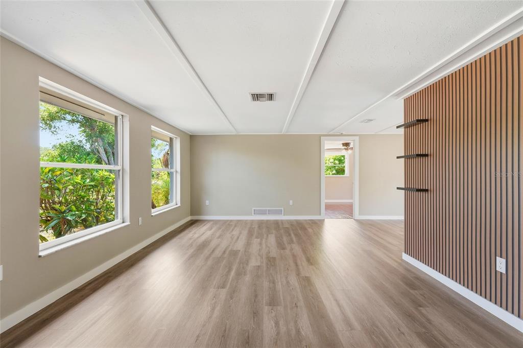 5984 Diana Road Venice, FL 34293 - Photo 7 of 36 a view of empty room with wooden floor and fan