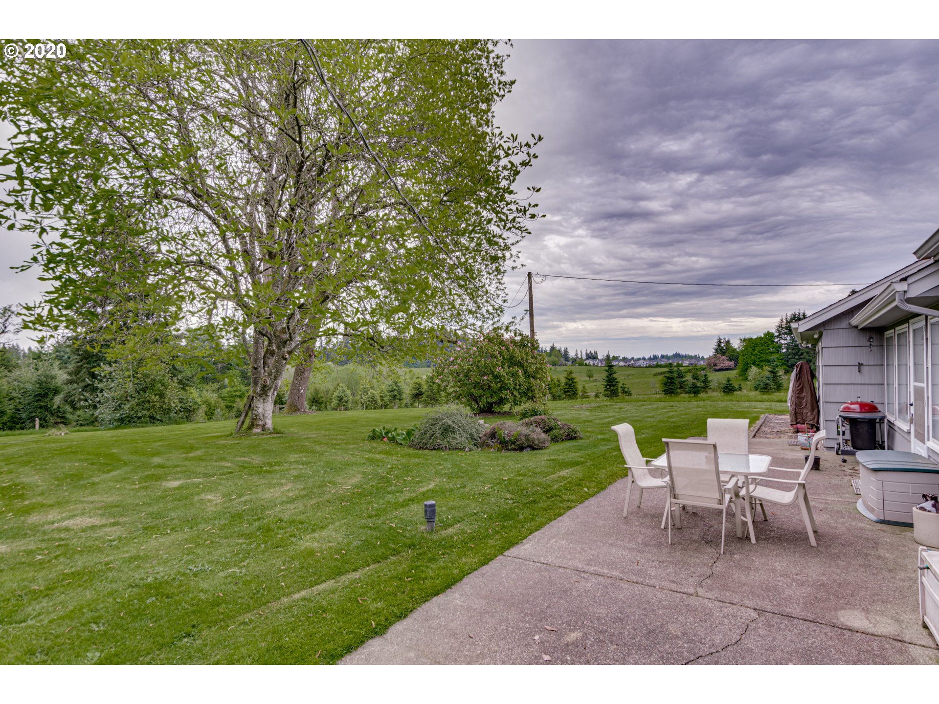 1650 North Royle Road Ridgefield, WA 98642 - Photo 17 of 32 a view of a backyard with table and chairs and a yard