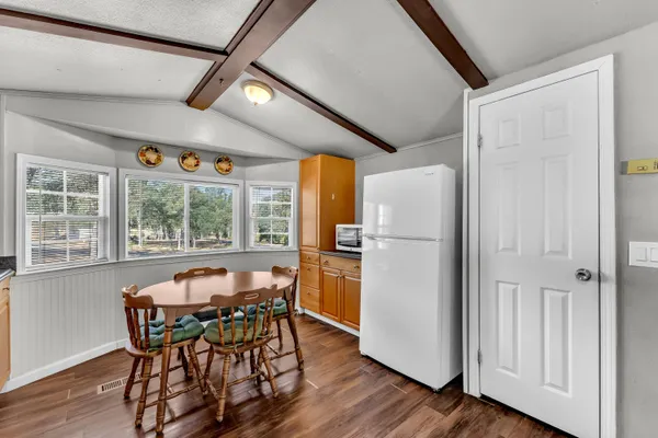 a dining room with furniture a window and wooden floor