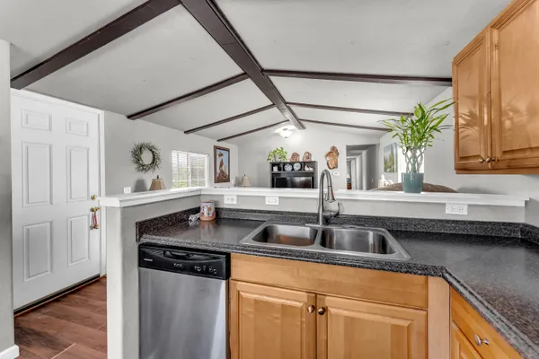 a kitchen with granite countertop a sink and a window