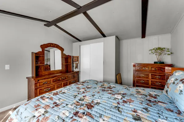 a bedroom with a bed and a dresser