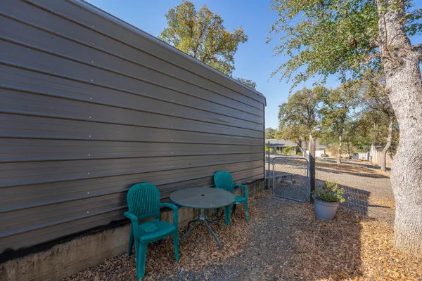 a backyard of a house with table and chairs