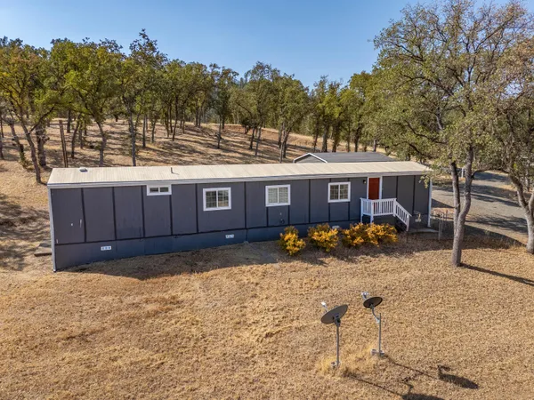 a view of a house with a yard covered in snow
