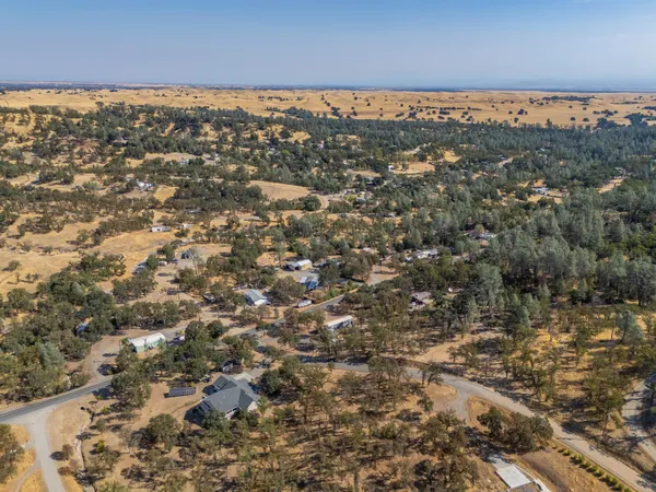 an aerial view of residential houses with city view