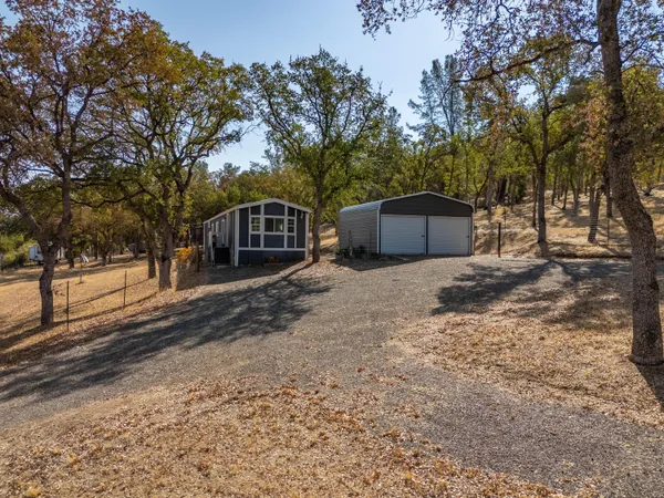 a view of a house with a yard covered in snow