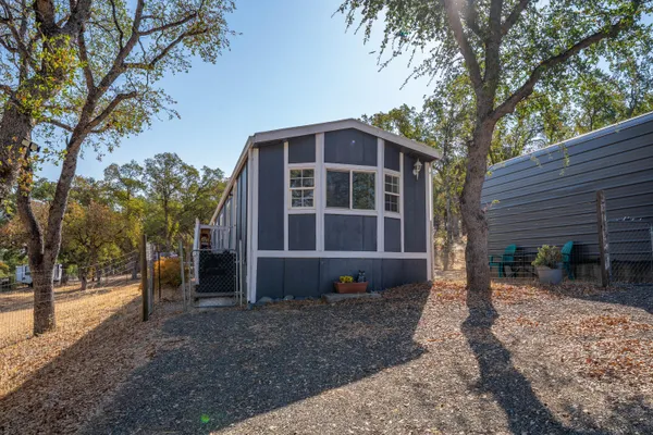 a view of a house with a yard and sitting area
