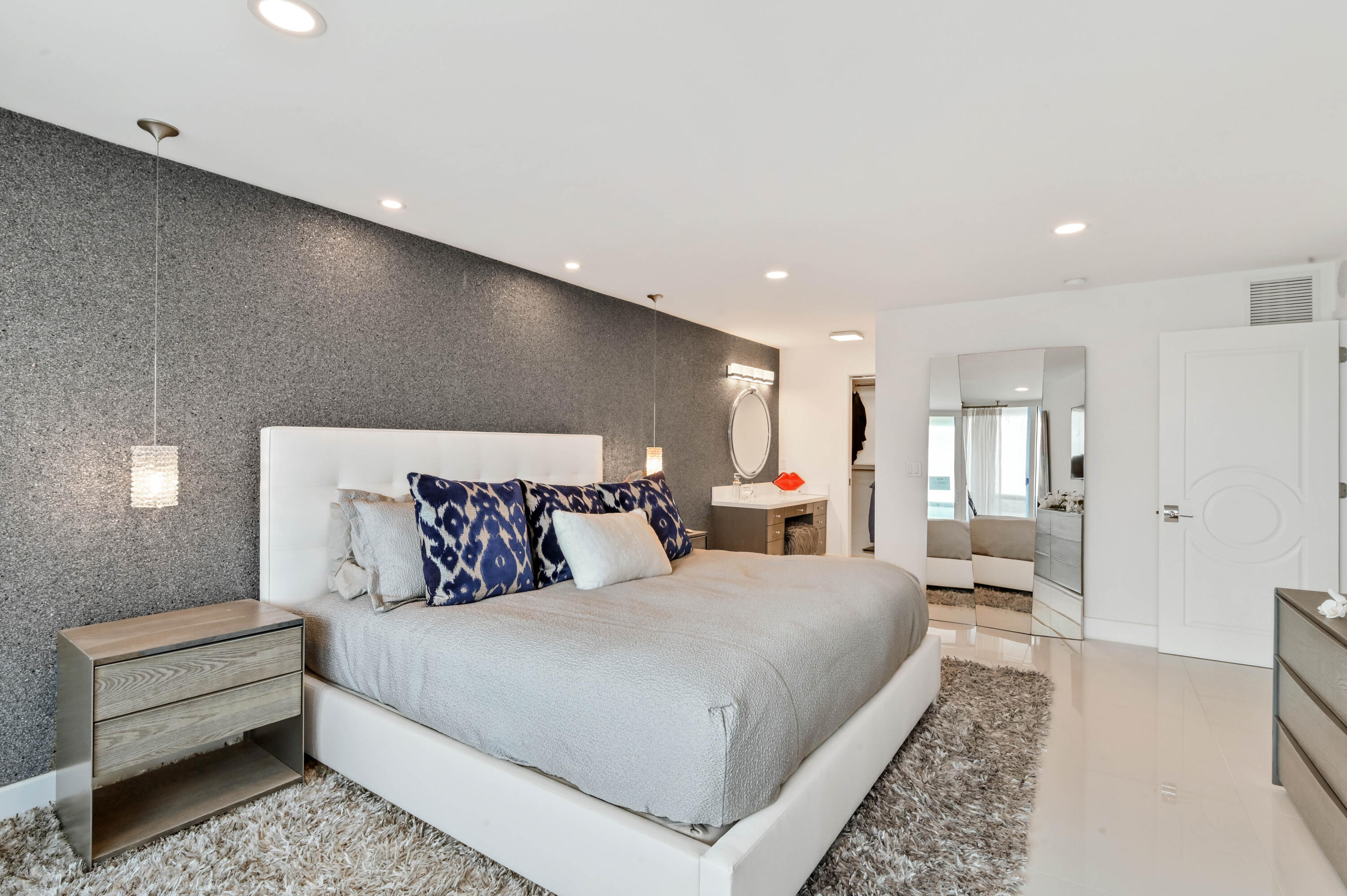 2800 South Ocean Boulevard, Unit 21E Boca Raton, FL 33432 - Photo 23 of 60 a large bedroom with a bed and wooden floor