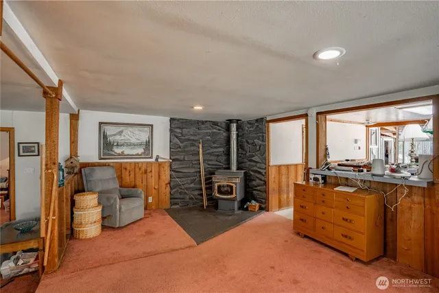 a living room with lots of furniture and a large window