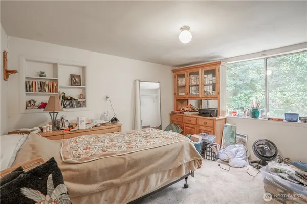 a living room with furniture a fireplace and a window