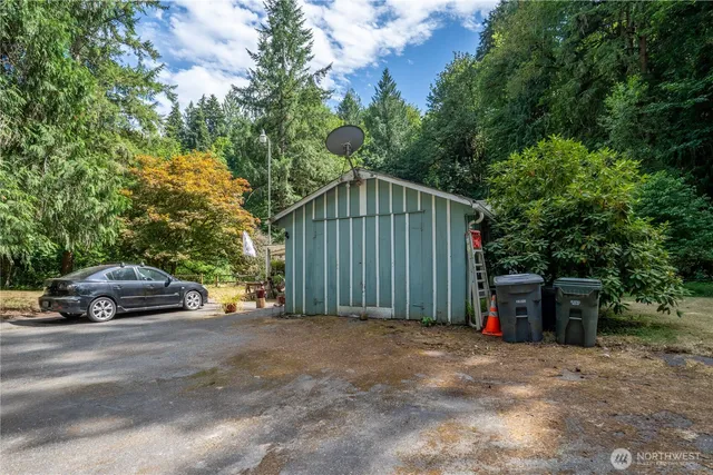 a backyard of a house with a yard and outdoor seating