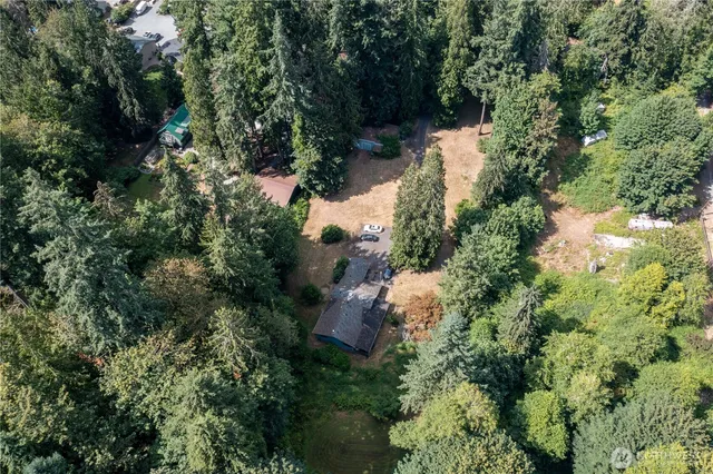 an aerial view of a house with yard