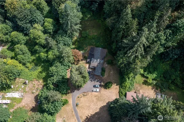 an aerial view of a house with outdoor space and street view