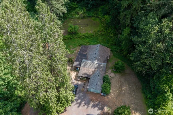 a view of a wooden house with a yard