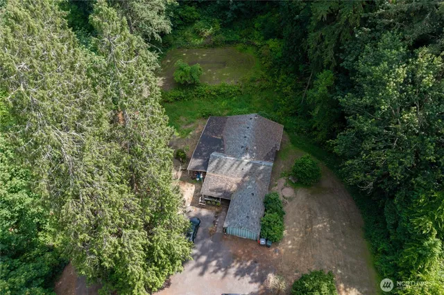 a view of a wooden house with a yard