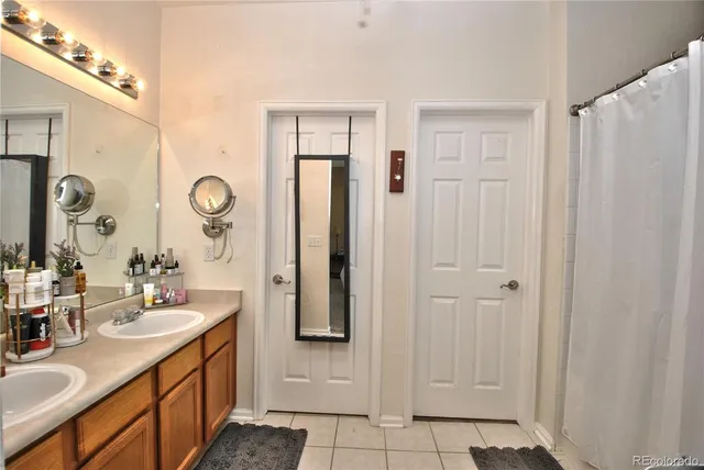 a bathroom with double vanity sink and a mirror