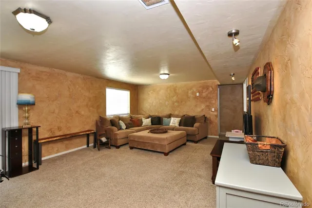 a bedroom with a bed and painting on the wall