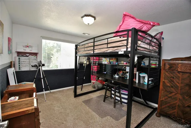 a view of a road with a house in the background