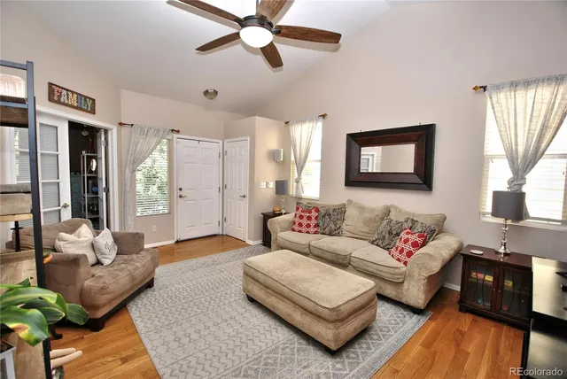 a living room with furniture and a wooden floor