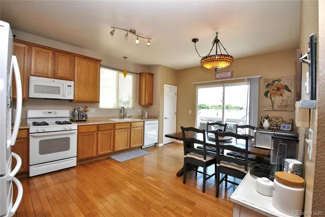 a kitchen with stainless steel appliances a table chairs and a chandelier