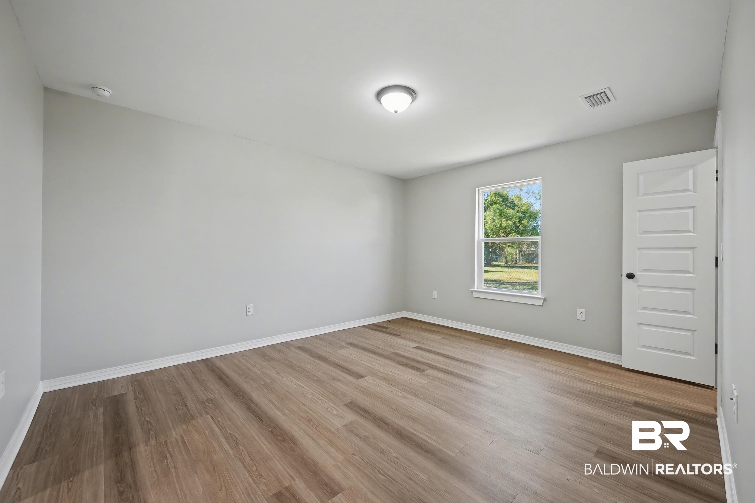 76 Fincher Lane Loxley, AL 36551 - Photo 16 of 33 Empty room featuring light wood finished floors and baseboards