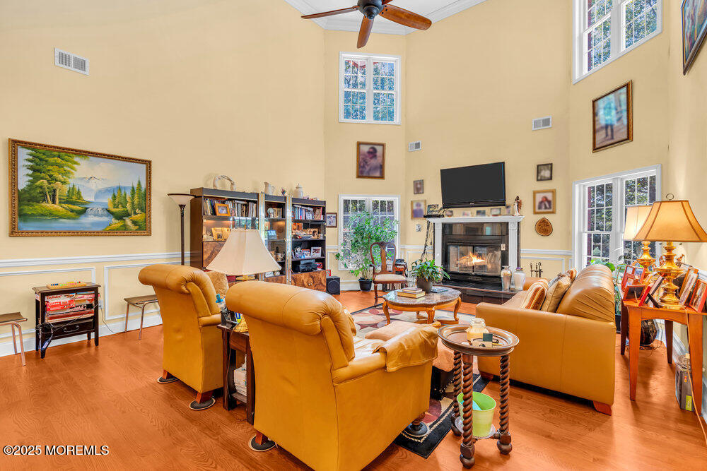 312 Clearstream Road Jackson, NJ 08527 - Photo 27 of 99 a living room with furniture a flat screen tv and a fireplace