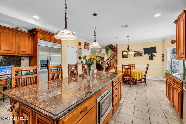 a living room with furniture and kitchen view