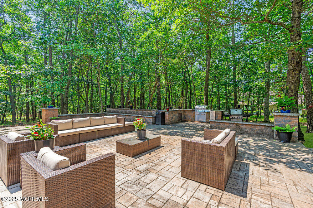 312 Clearstream Road Jackson, NJ 08527 - Photo 75 of 99 a view of a patio with couches chairs and a fire pit