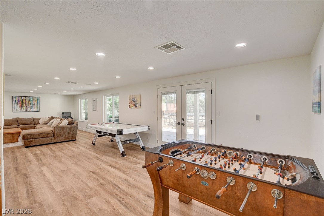 4362 Thistle Street Logandale, NV 89021 - Photo 43 of 99 Ample entertainment space awaits with plenty of room for dual game tables and direct outdoor access through French doors.