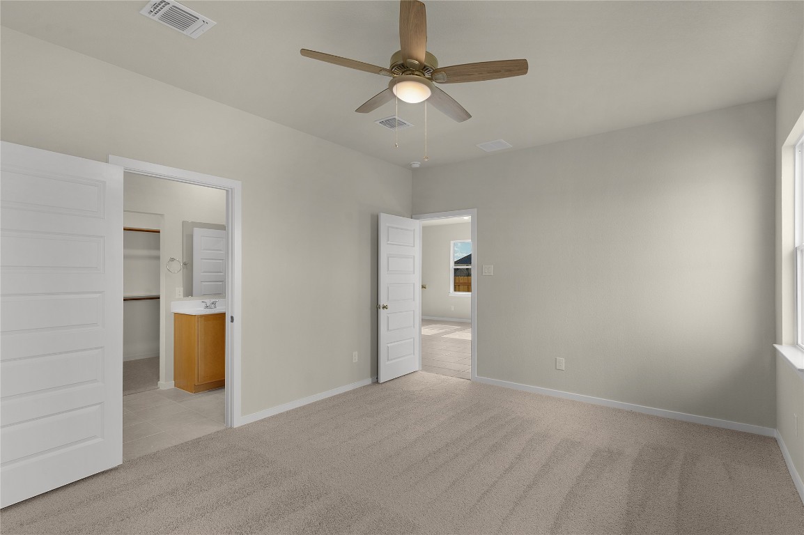 25624 Wheat Seed Lane Elgin, TX 78621 - Photo 25 of 40 an empty room with a window and a ceiling fan