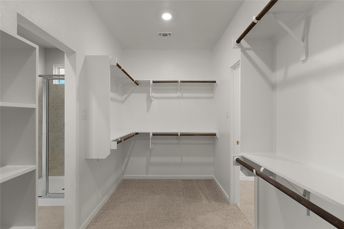 25624 Wheat Seed Lane Elgin, TX 78621 - Photo 28 of 40 a view of walk in closet with empty racks