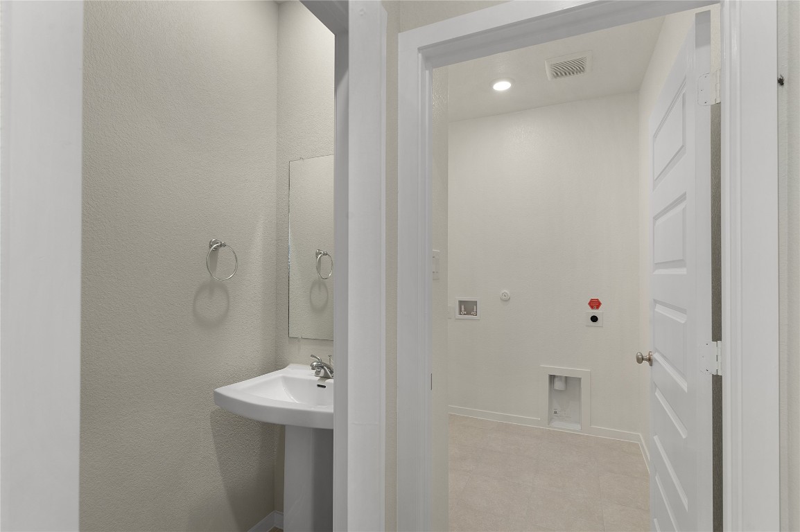 25624 Wheat Seed Lane Elgin, TX 78621 - Photo 29 of 40 a bathroom with a sink and mirror