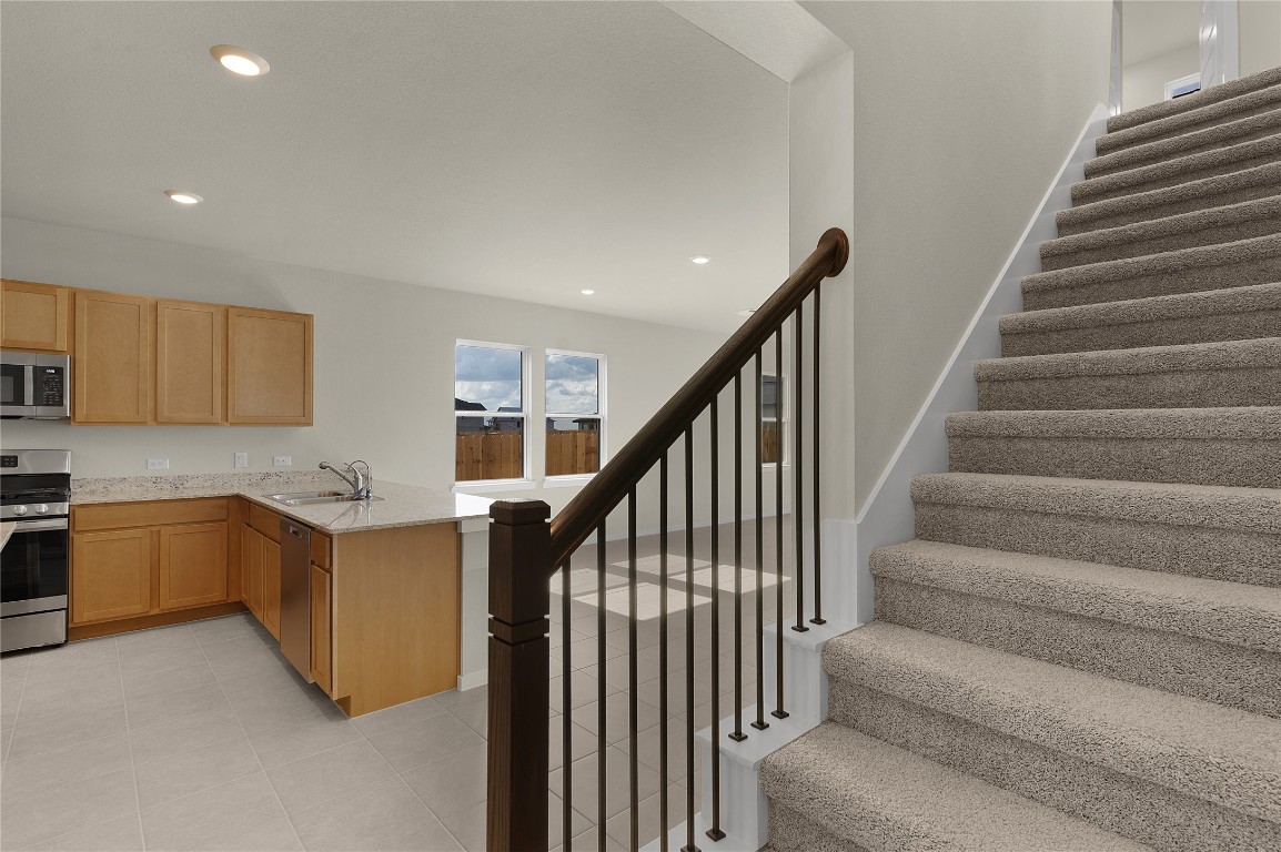 25624 Wheat Seed Lane Elgin, TX 78621 - Photo 30 of 40 a view of entryway and kitchen with wooden floor